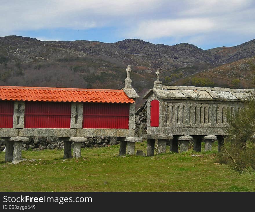 Two granaries on a country landscape