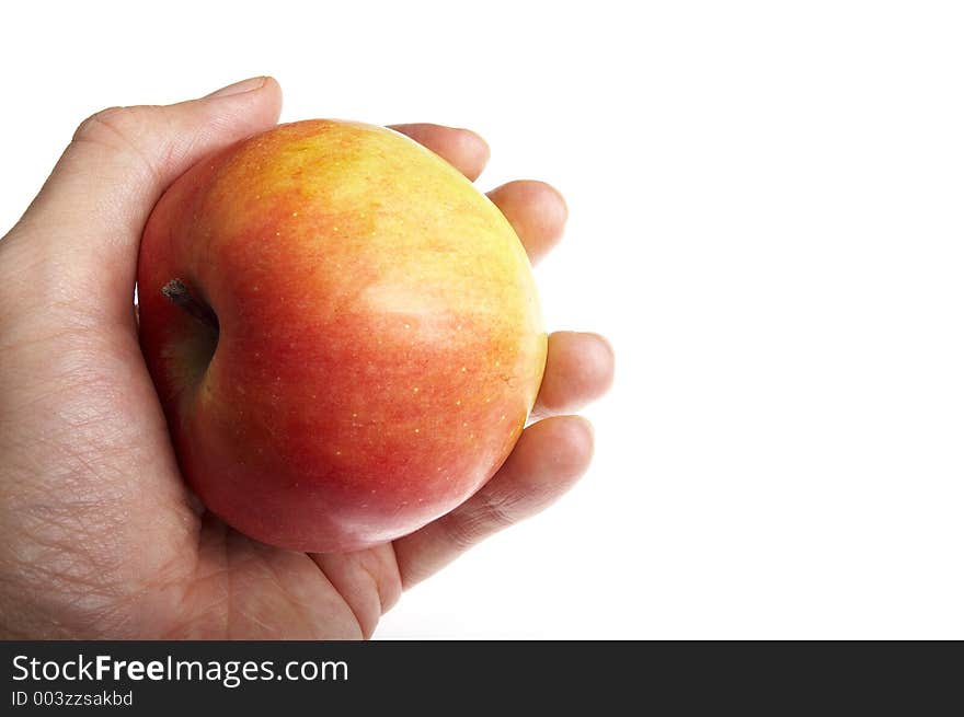 Red apple in a hand on a white background