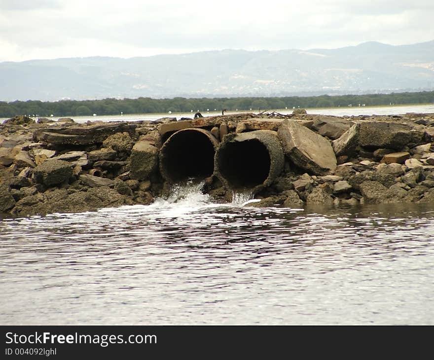 As the tide lowers, the flats drain of water. These two pipes allow water into a boat channel. As the tide lowers, the flats drain of water. These two pipes allow water into a boat channel.