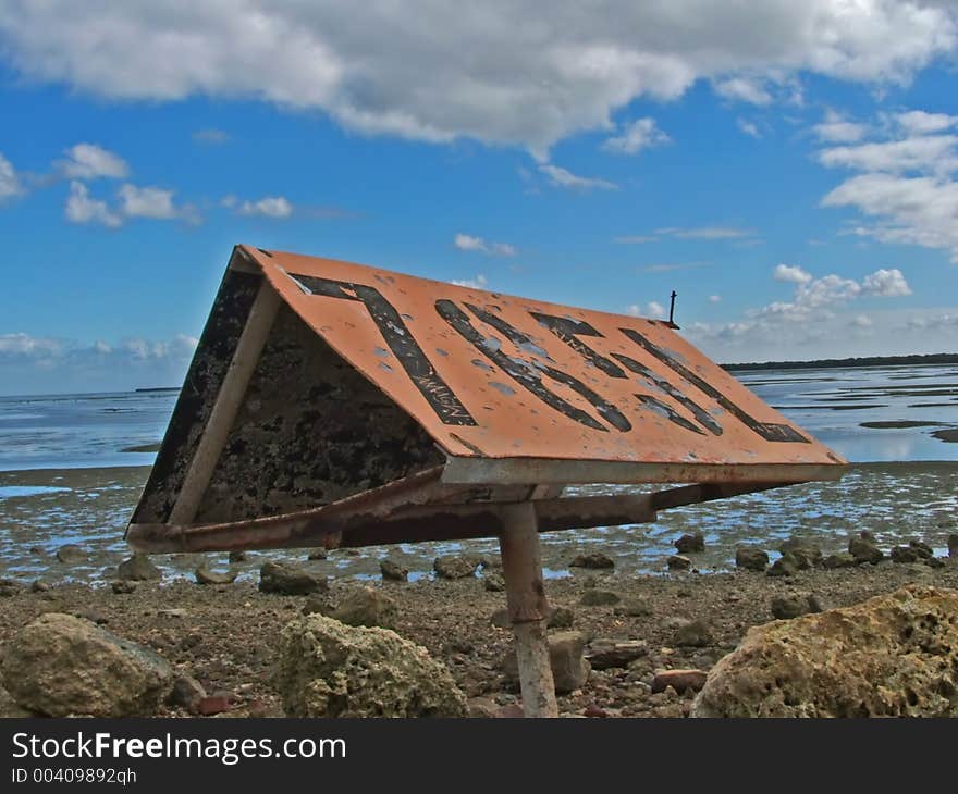 A sign situated on a breakwater. A sign situated on a breakwater