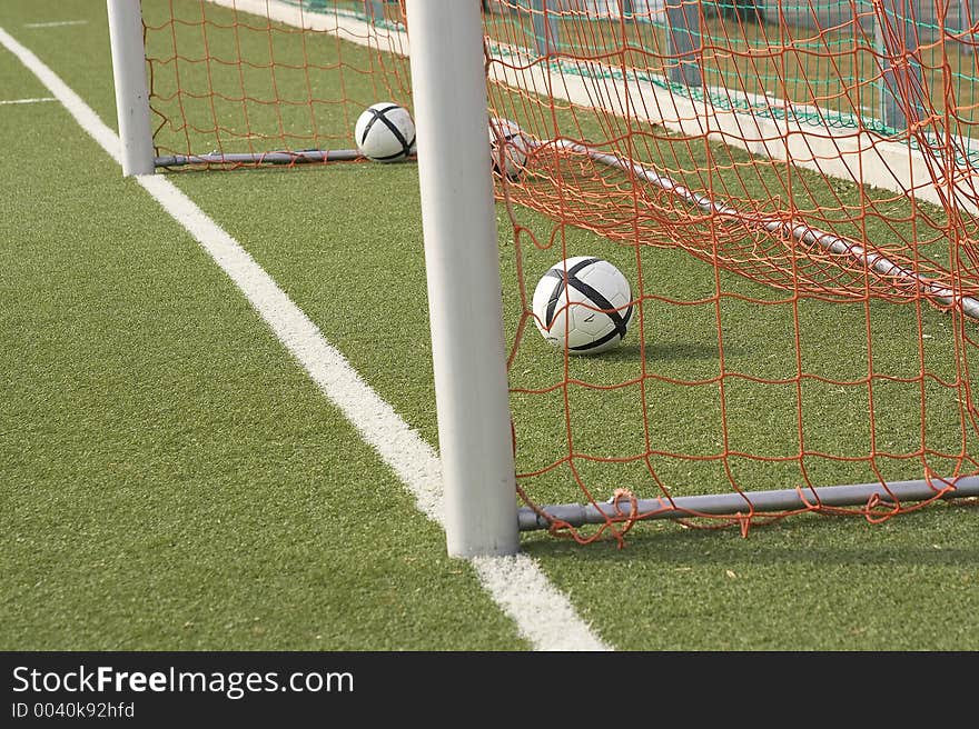 Two Balls laying in a goal. Two Balls laying in a goal