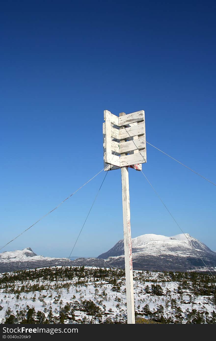 Top of the mountain post against a blue sky. Top of the mountain post against a blue sky