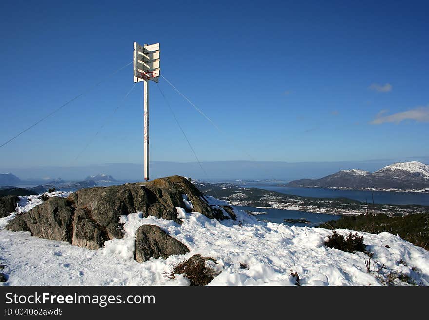 Top of the mountain post against a blue sky. Top of the mountain post against a blue sky