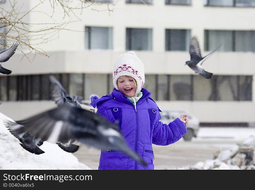 The girl feeds pigeons. The girl feeds pigeons.