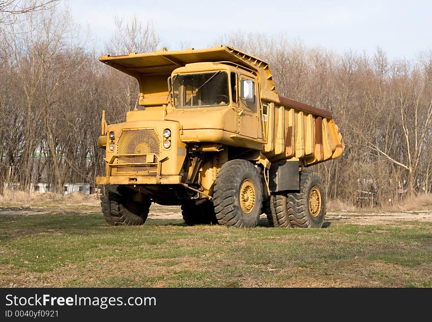 Old yellow dump truck outside