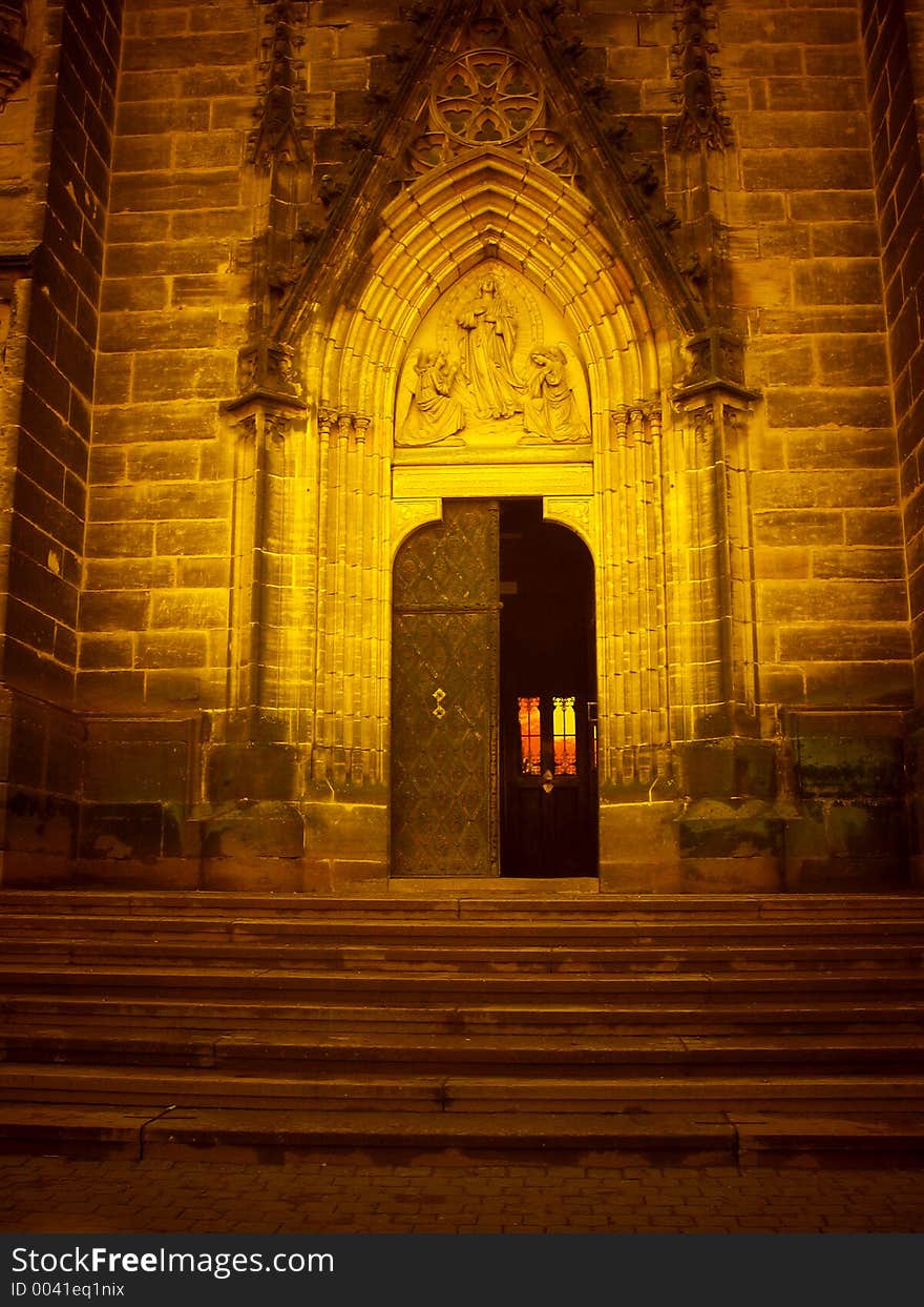 Doorway of gothic church in special lighting of sunset colors. Doorway of gothic church in special lighting of sunset colors