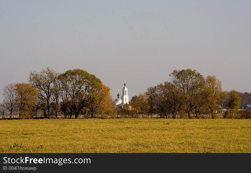 View of a church among autumn trees. View of a church among autumn trees