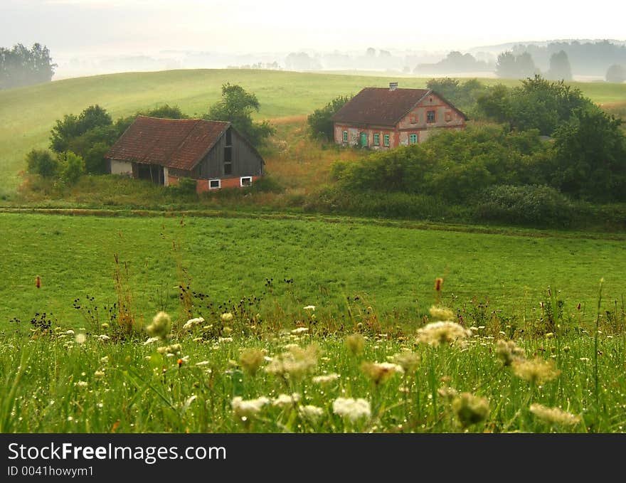 Old farm in foggy morning