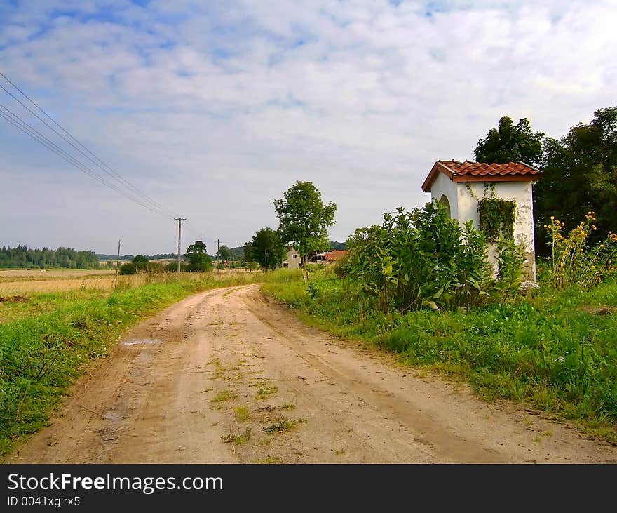 Contry road with wayside shrine. Contry road with wayside shrine