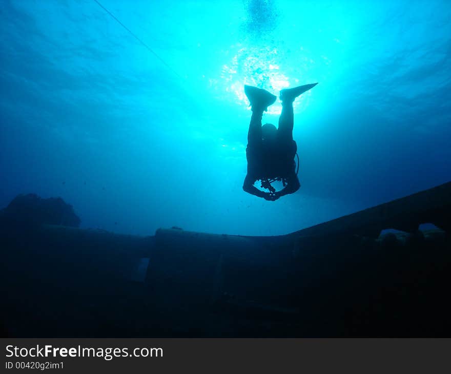 Another shot of a diver surfacing from the wreck, nice effect with the sun. Another shot of a diver surfacing from the wreck, nice effect with the sun.