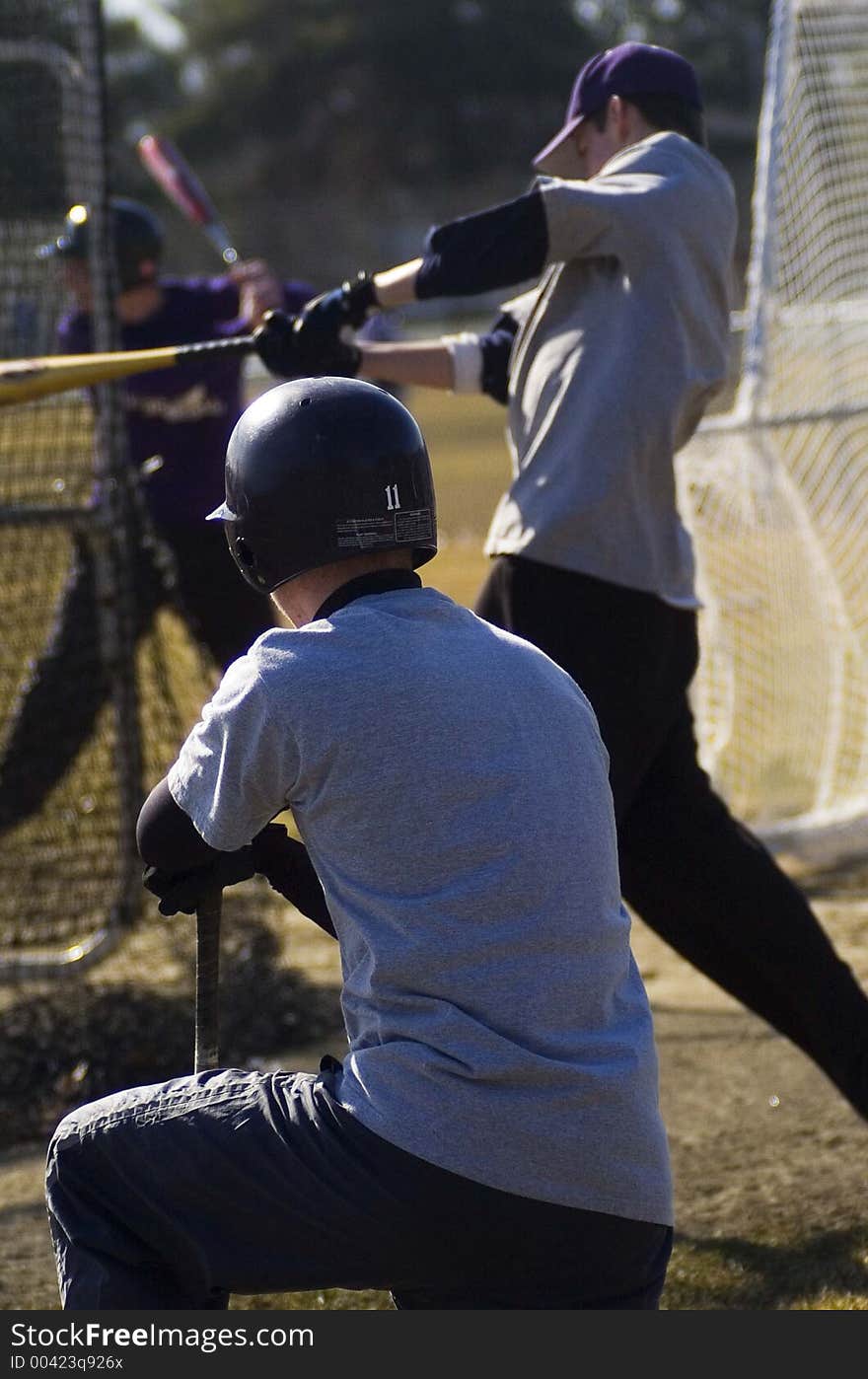 High School baseball player in spring training working on hitting.