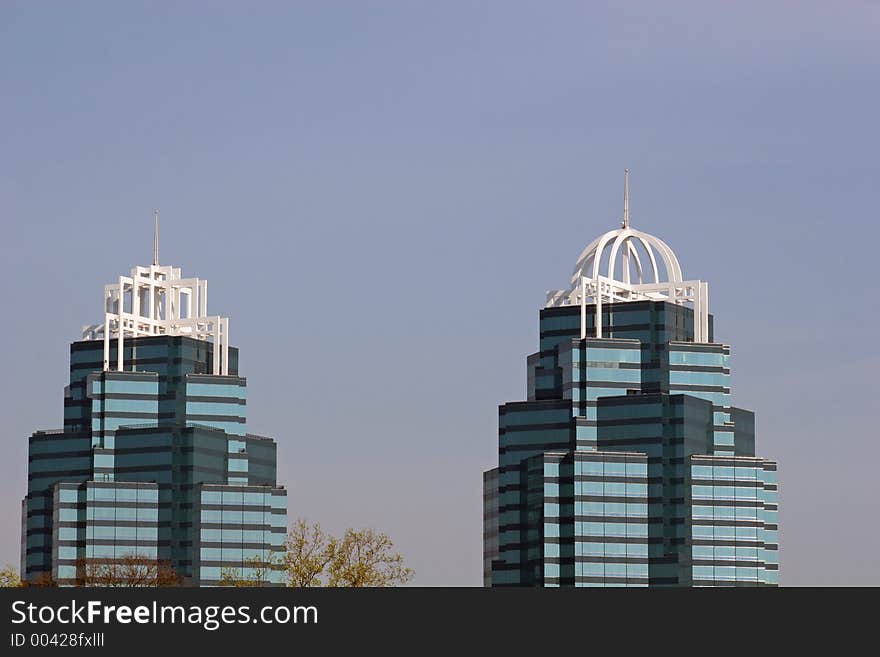 Twin office towers against sky. Room for ad copy. Twin office towers against sky. Room for ad copy