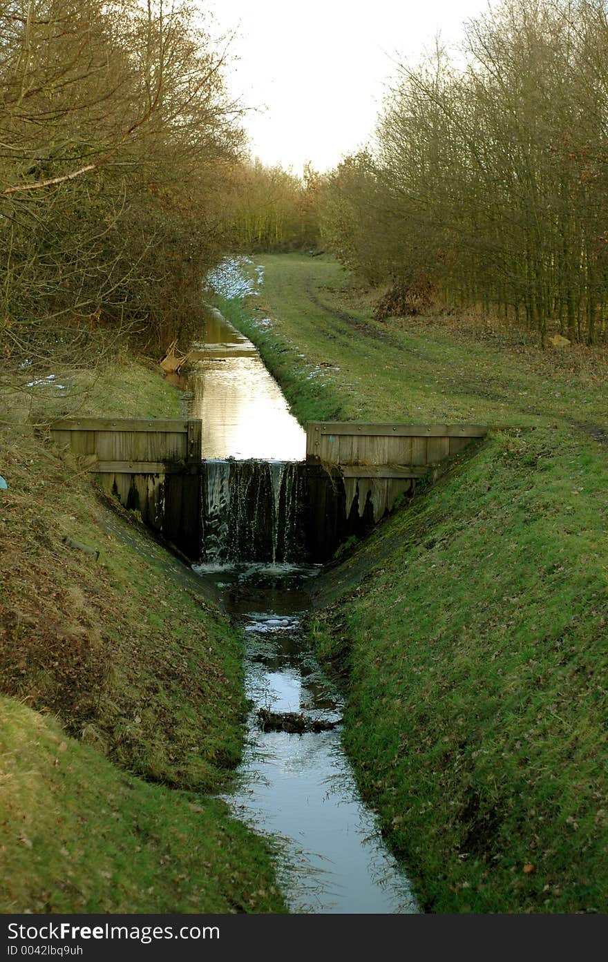 A small waterfall between two forests