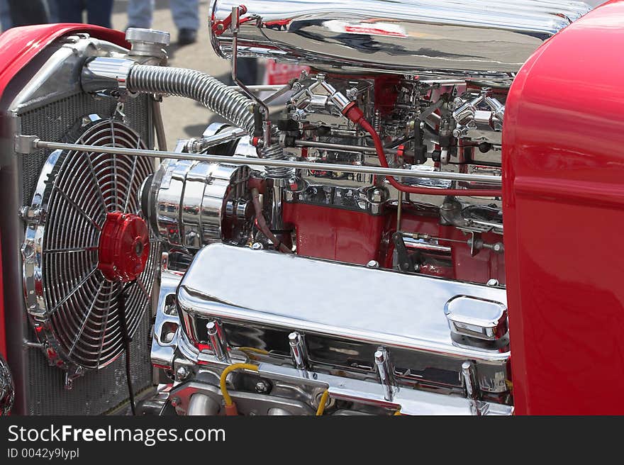 Closeup of motor in street rod in parade going through town. Closeup of motor in street rod in parade going through town