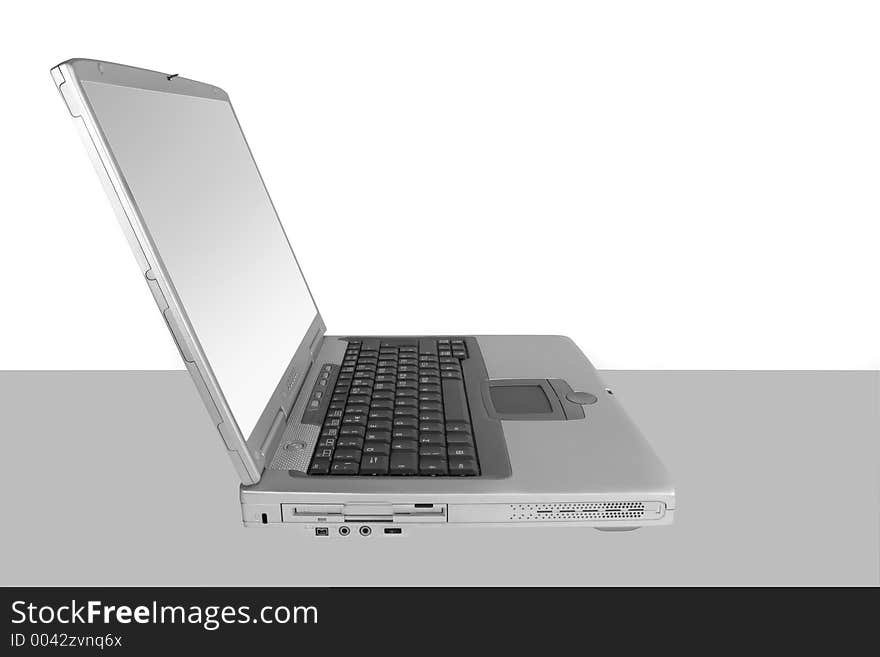 Silver laptop with a white and silver screen set against a white and grey background. Silver laptop with a white and silver screen set against a white and grey background