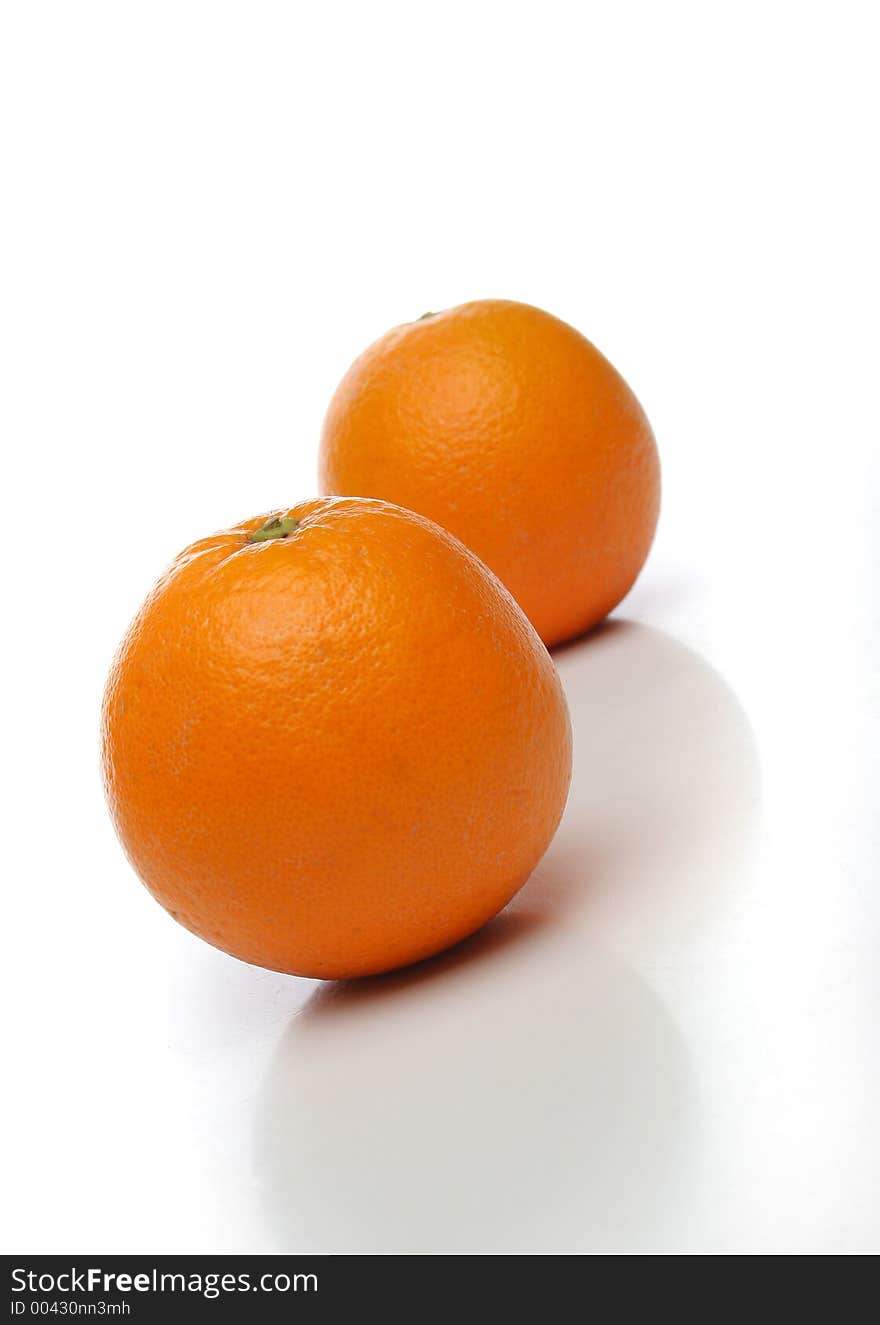 A pair of juicy oranges, one on front and one backwards over a white background. Look at my gallery for more fruits and vegetables