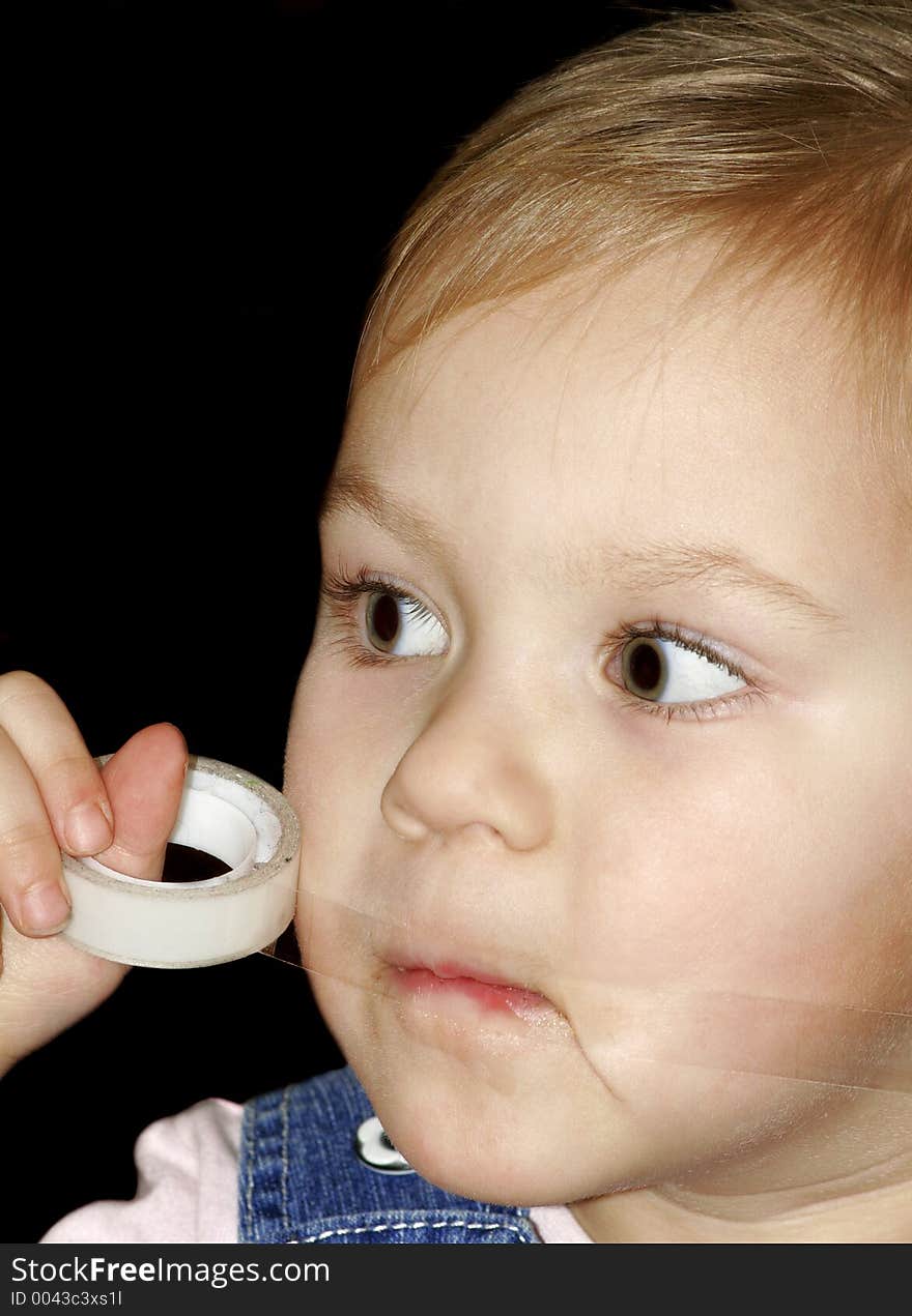 Girl sticking a mouth by a sticky tape. Girl sticking a mouth by a sticky tape