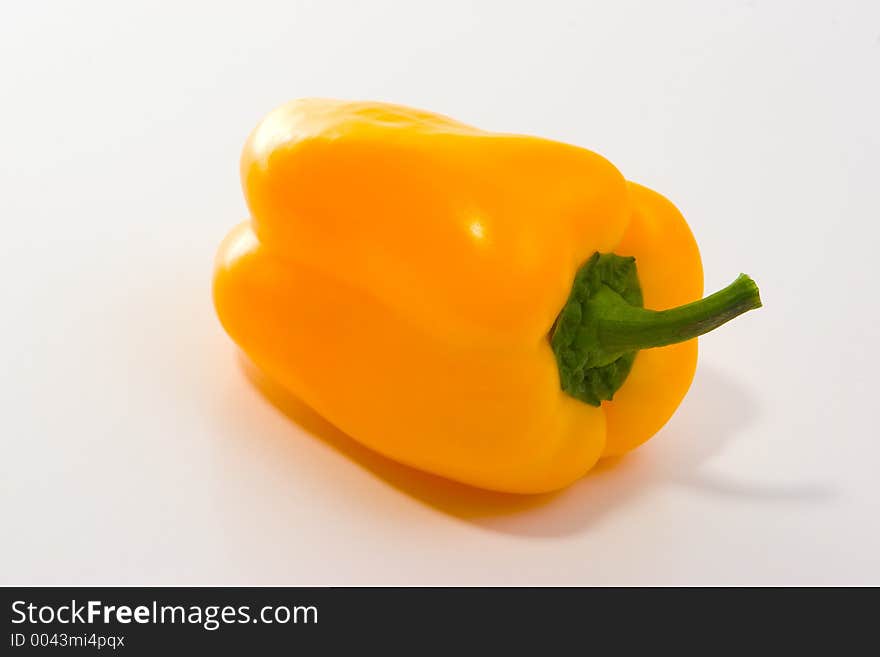 Studio work, yellow pepper on white table. Studio work, yellow pepper on white table