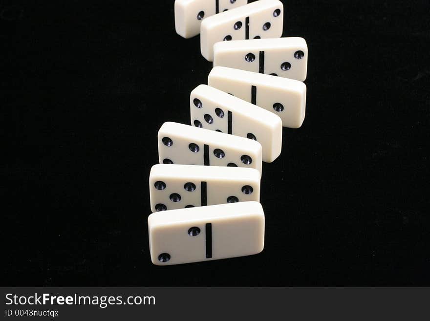 Roll of dominoes on a black background. Roll of dominoes on a black background.