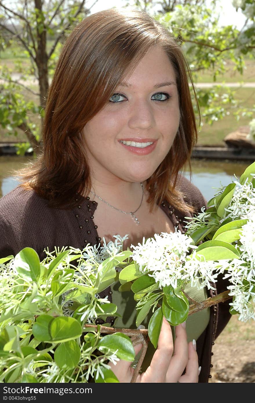 Teenage girl poses with some flowers. Teenage girl poses with some flowers.