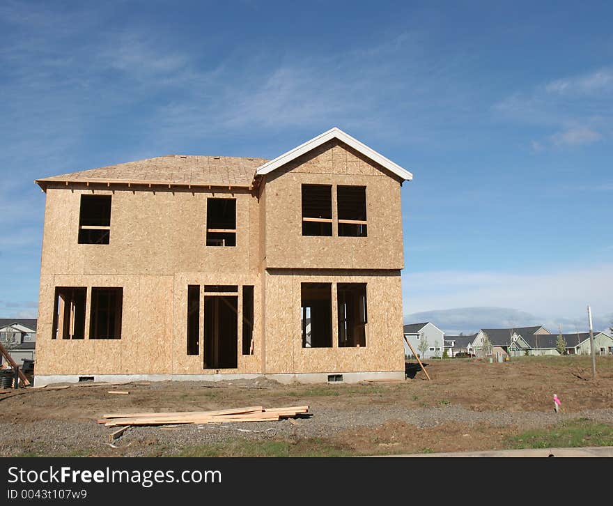 House under construction in suburban development. House under construction in suburban development.