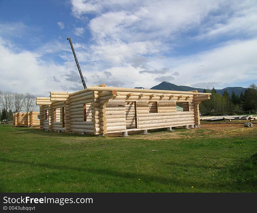 A Large Crane is Used to Assemble Log Cabin prior to disassembly and shipment, possibly overseas. A Large Crane is Used to Assemble Log Cabin prior to disassembly and shipment, possibly overseas