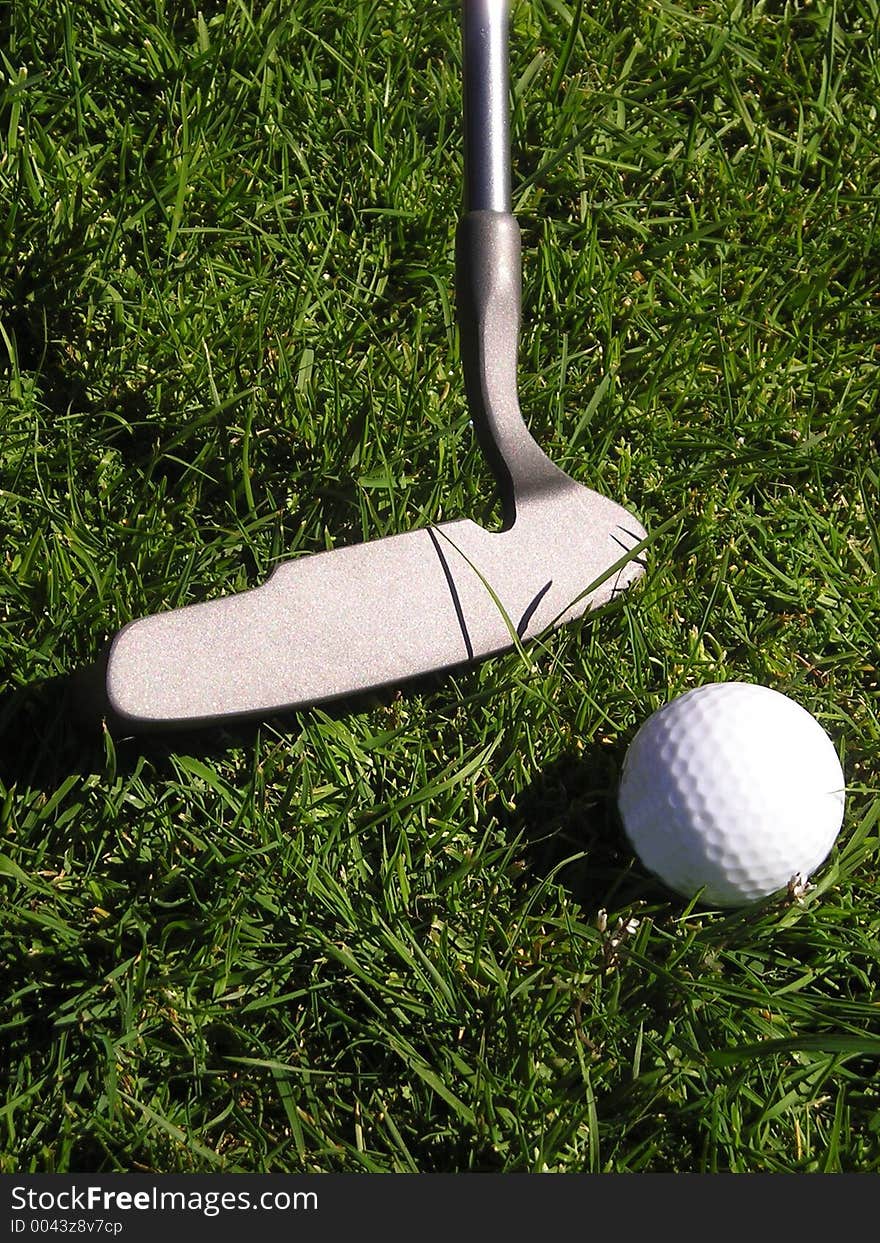 Golf putter and ball on grass. Golf putter and ball on grass