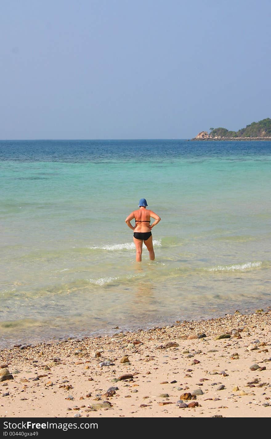 Women walking alone in the sea. Women walking alone in the sea.