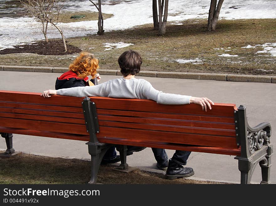 Spring song on bench in park