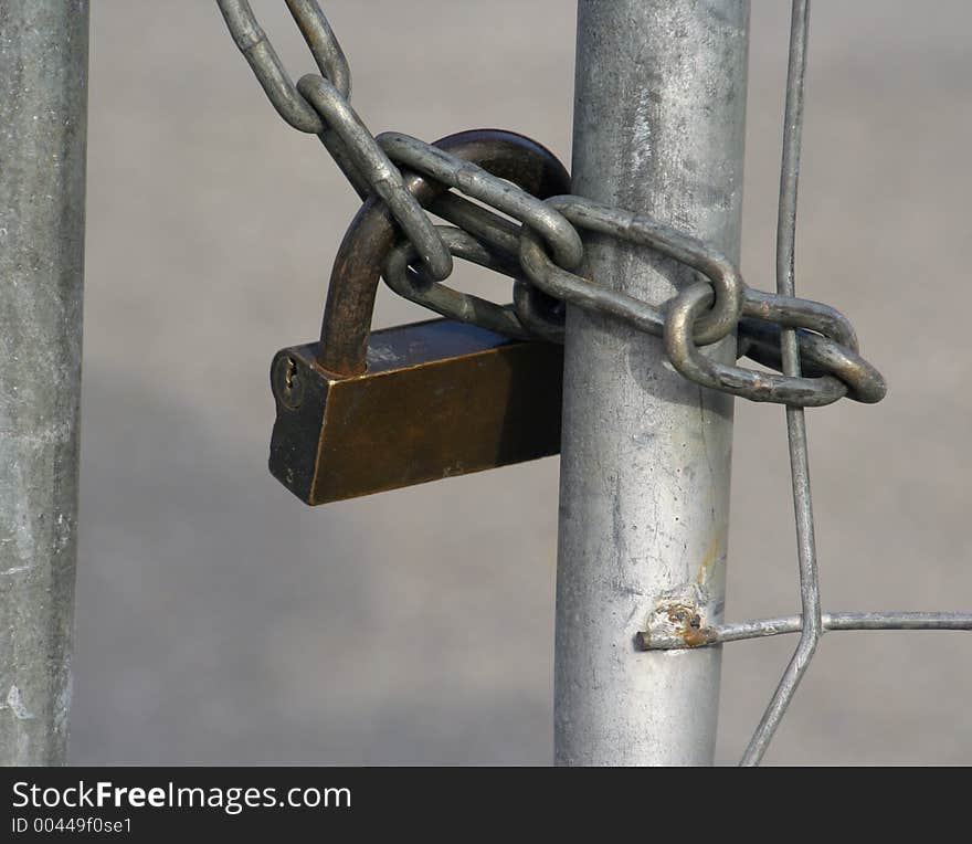 Close up of a large lock and chain securing an urban building. Close up of a large lock and chain securing an urban building