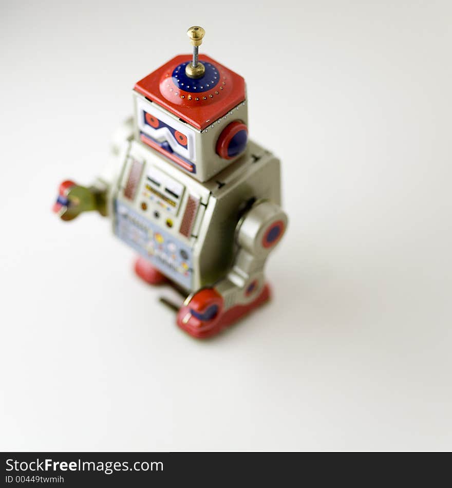 Toy metal robot walking towards its key