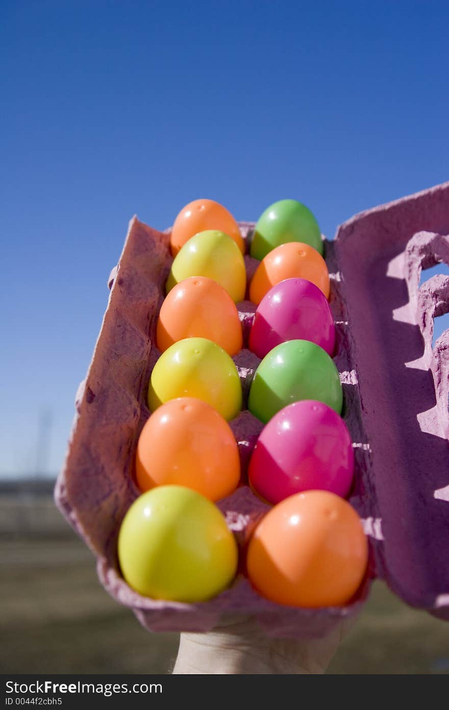 A dozon easter eggs in an egg carton