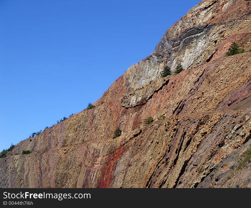 Cut rock against clear blue sky