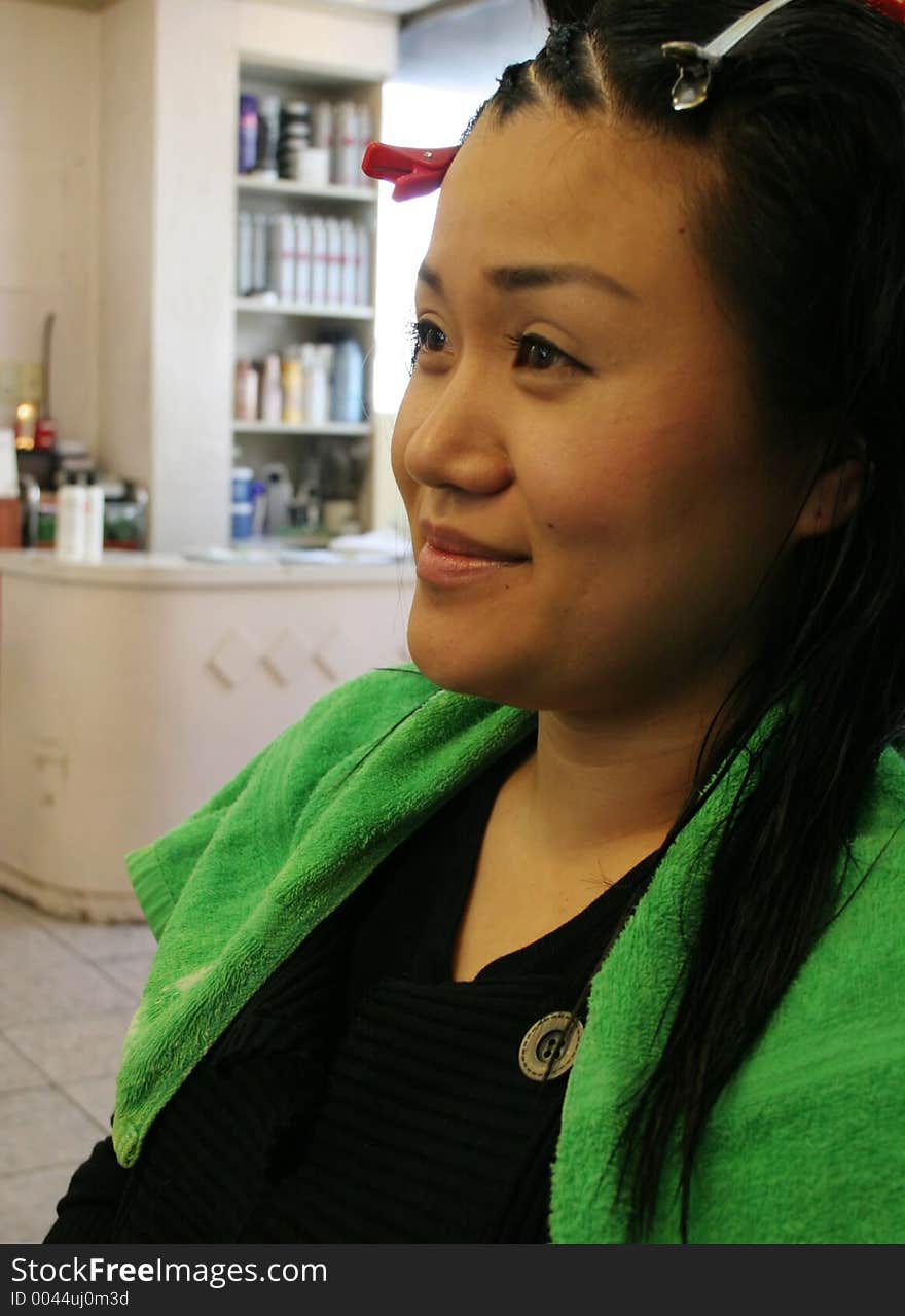 Asian woman having her hair done at the hairdresser