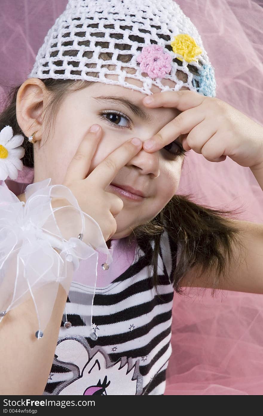 Gorgeous little girl sneaking a peek on a hide&seek game. Gorgeous little girl sneaking a peek on a hide&seek game