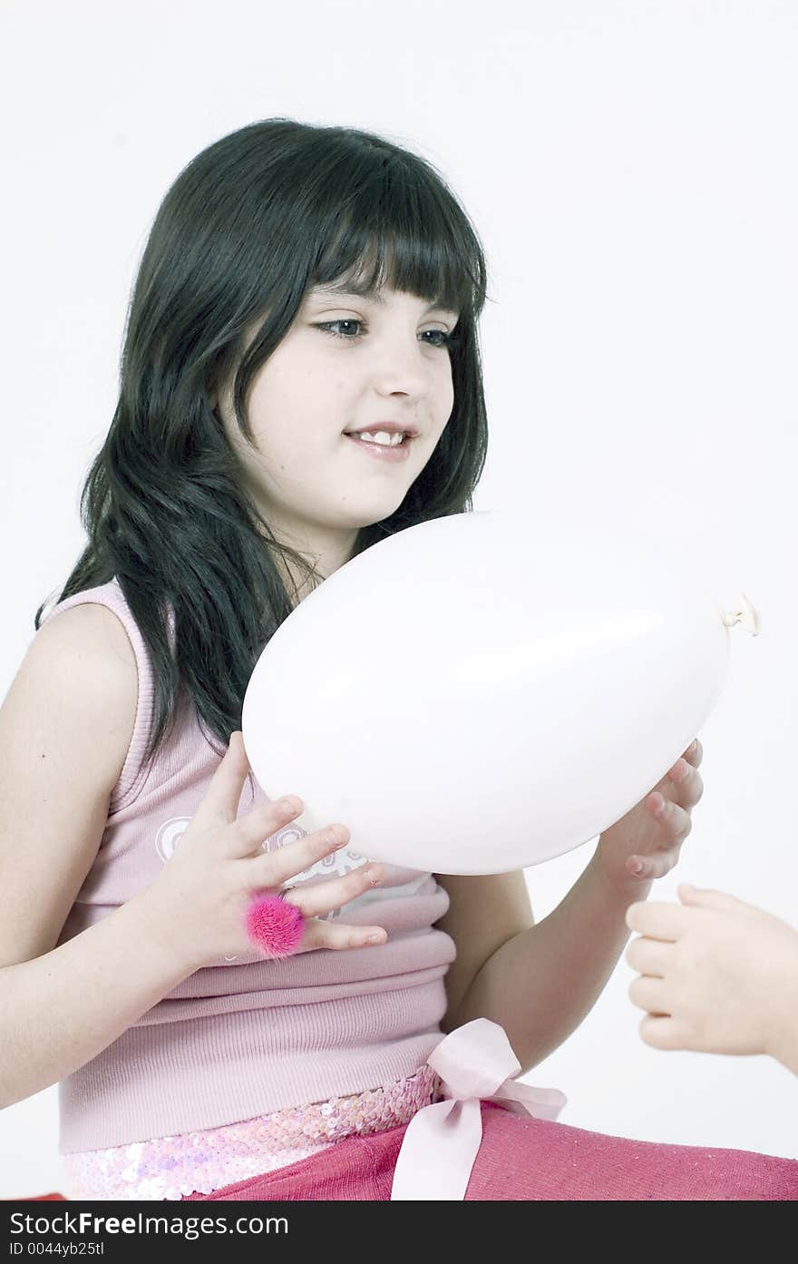 Pretty little girl playing with a white balloon. Pretty little girl playing with a white balloon