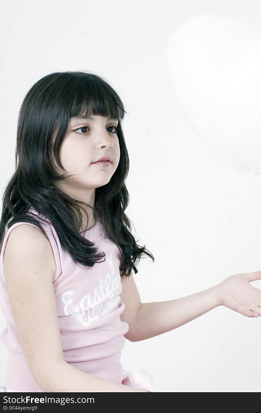 Little girl wondering why are balloons so light - inquisitive mind. Little girl wondering why are balloons so light - inquisitive mind