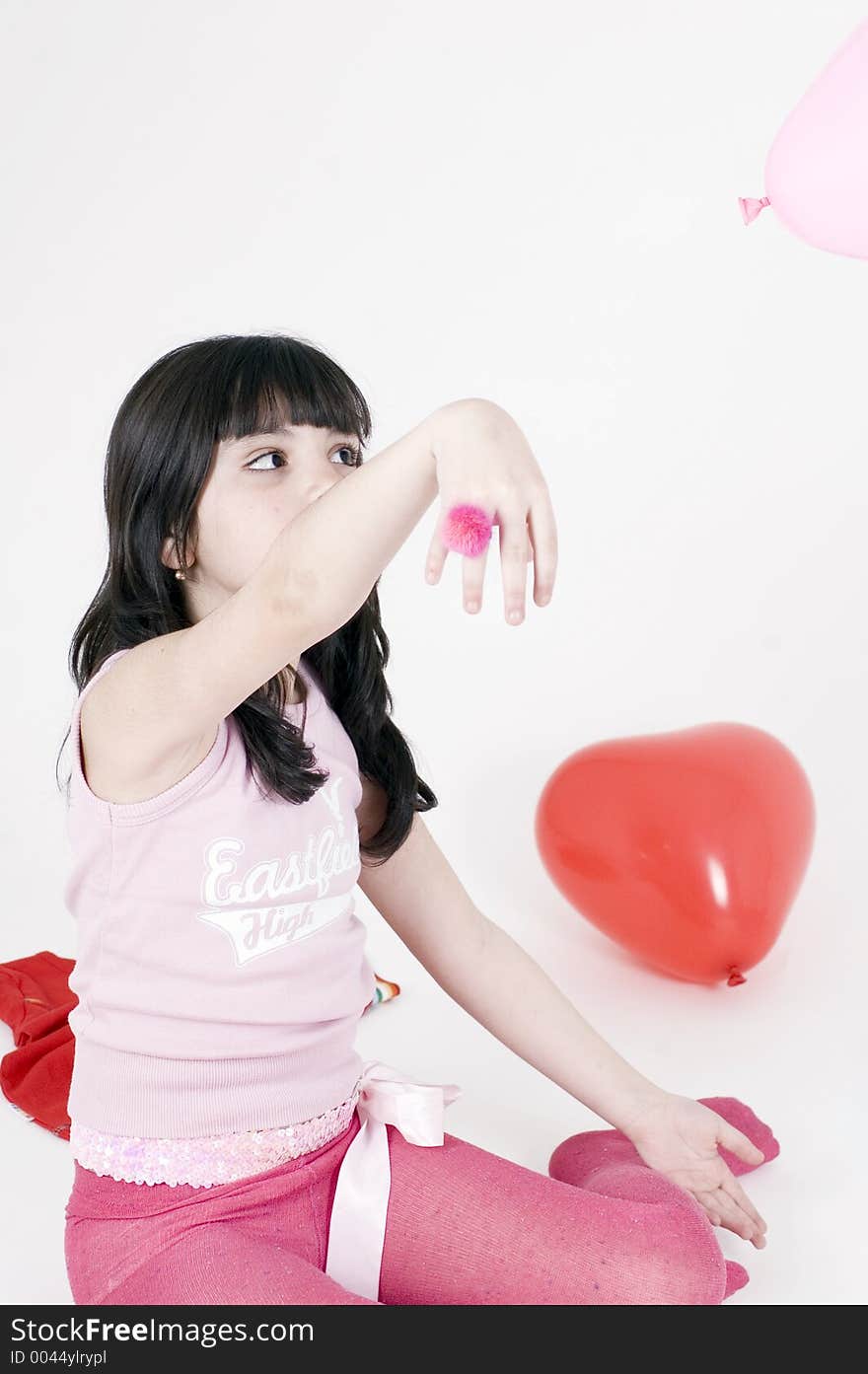 Little girl playing with balloons