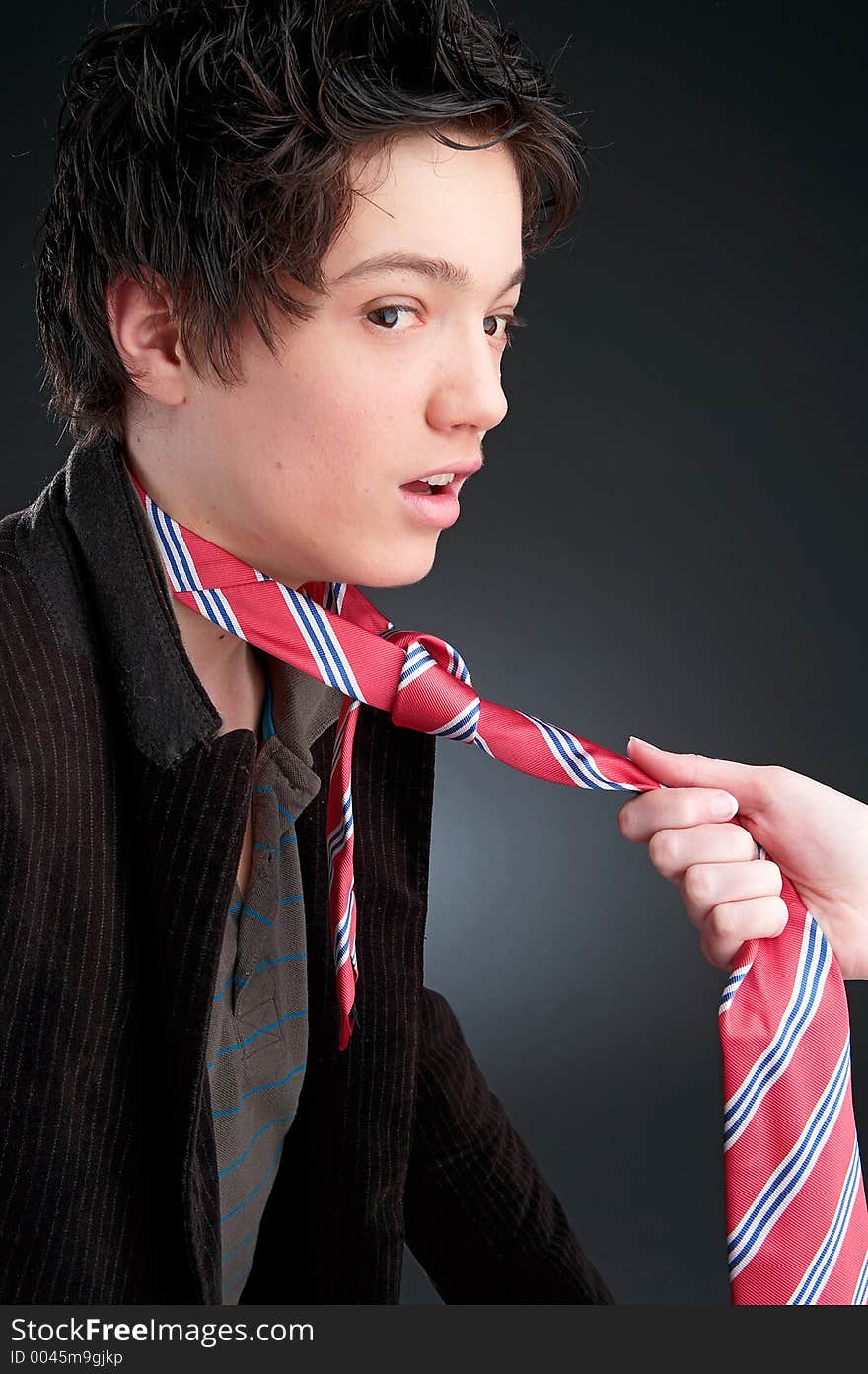 Young man on dark Background with red tie. Young man on dark Background with red tie