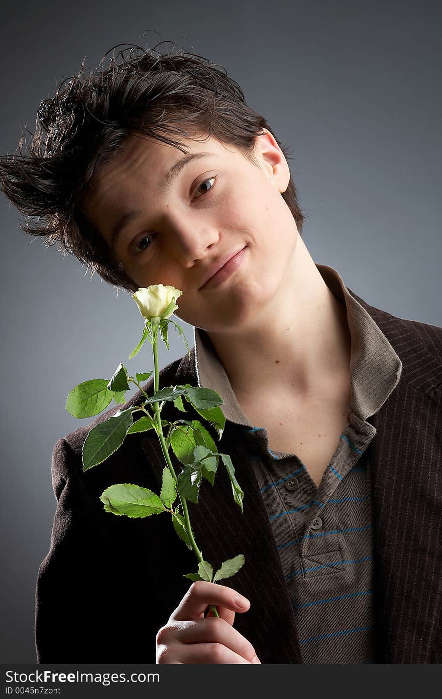 Young man on dark Background with yellow roses