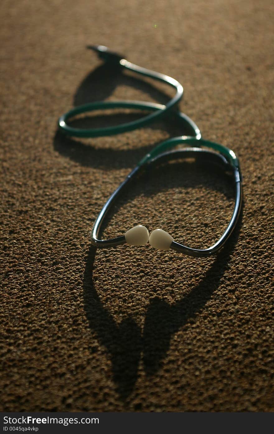 An image of a stethoscope and shadow, an essential tool for a doctor or nurse or anyone in the medical profession.