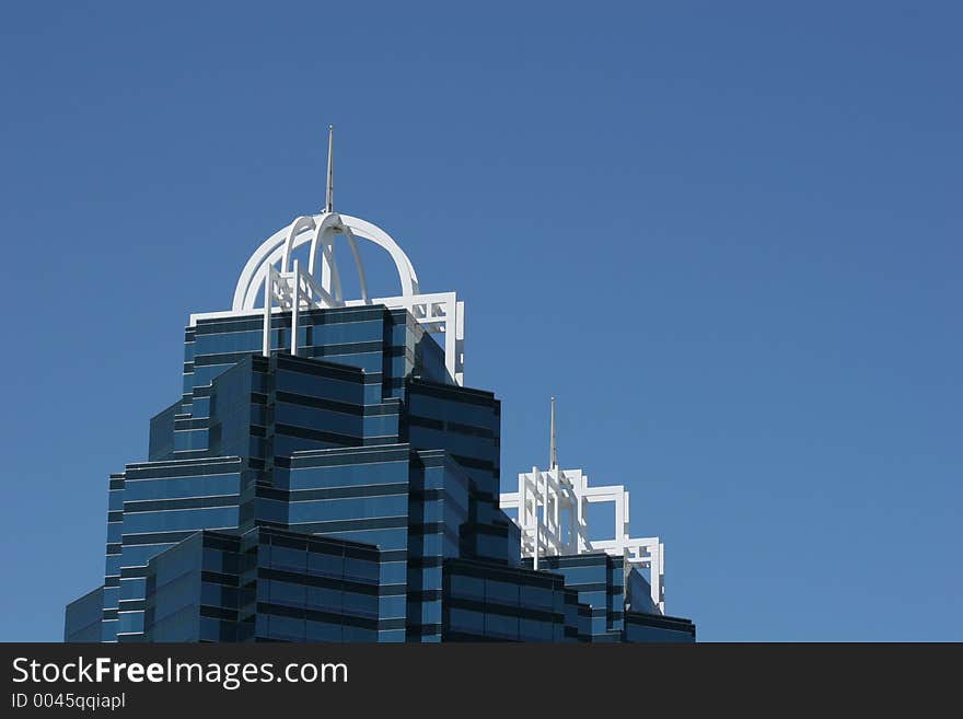 Twin office towers against blue sky. Twin office towers against blue sky