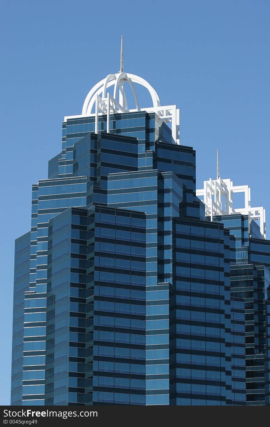 Twin office towers against blue sky. Twin office towers against blue sky