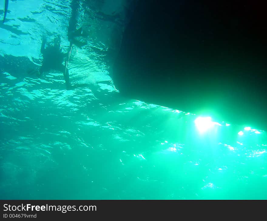 A diver retuns to their dive boat. A diver retuns to their dive boat