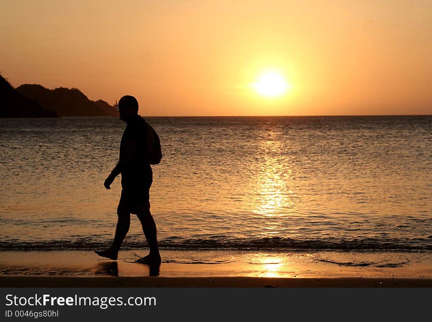 Man watching sunset *** Local Caption *** Man watching sunset. Colombia. Taganga Bay.