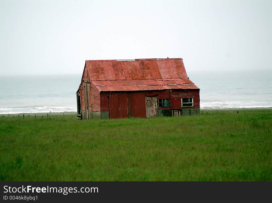 Red barn on coast line of southern New Zealand. Red barn on coast line of southern New Zealand