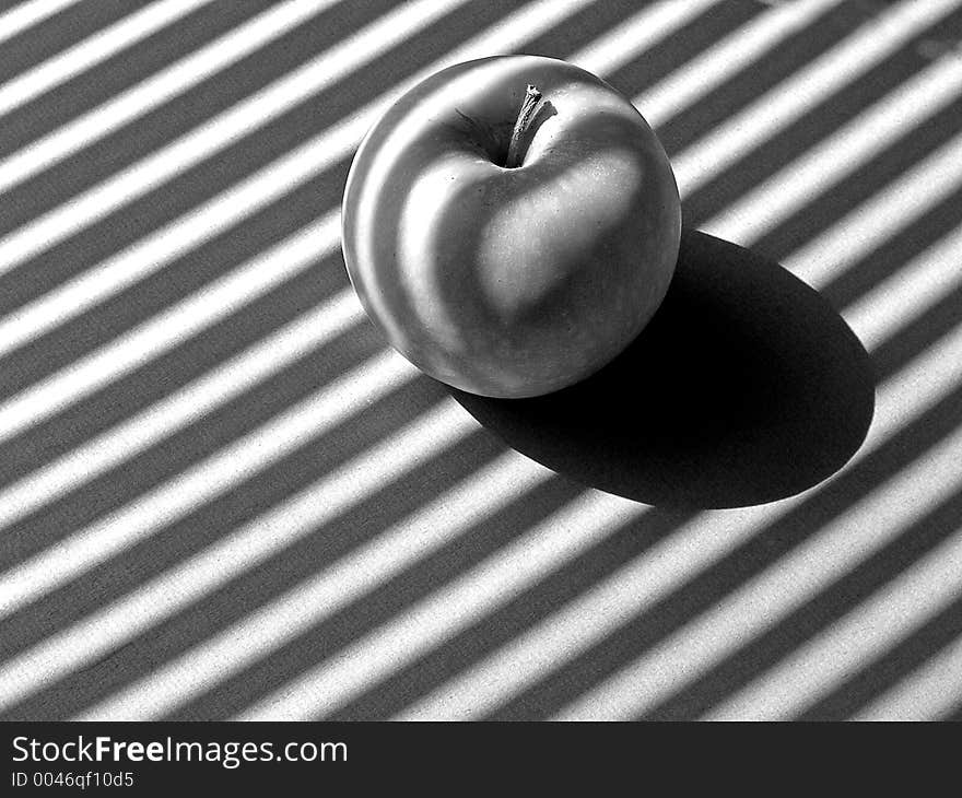 Apple in striped sunlight. Apple in striped sunlight