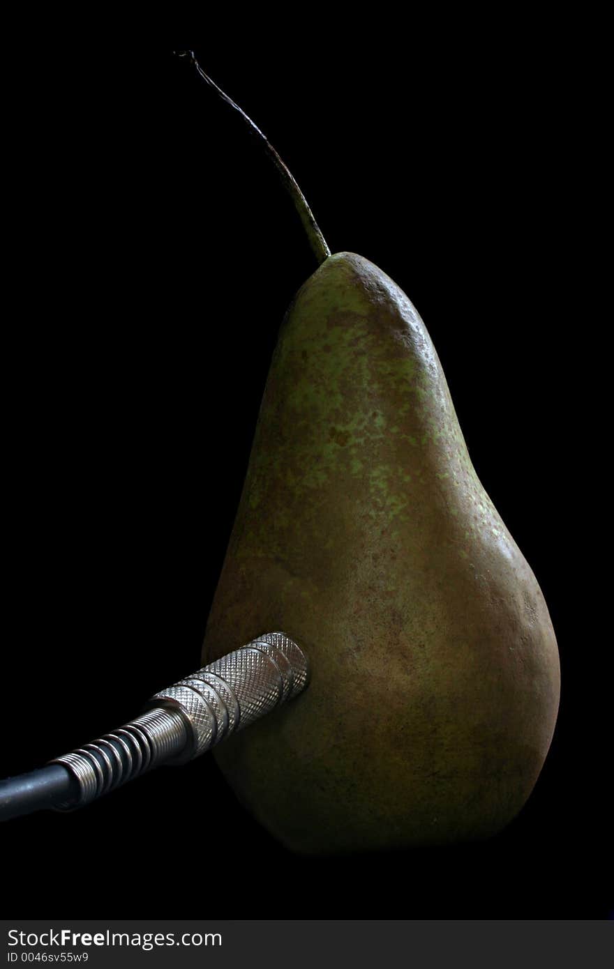 Image of a single pear plugged into an electrical current - conceptual energy. Image of a single pear plugged into an electrical current - conceptual energy