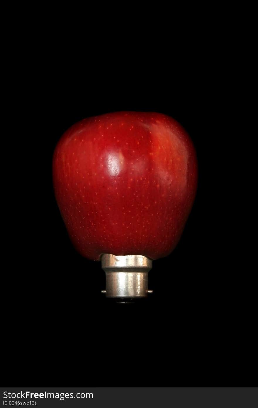 Image of an apple plugged into a light bulb - conceptual energy. Image of an apple plugged into a light bulb - conceptual energy