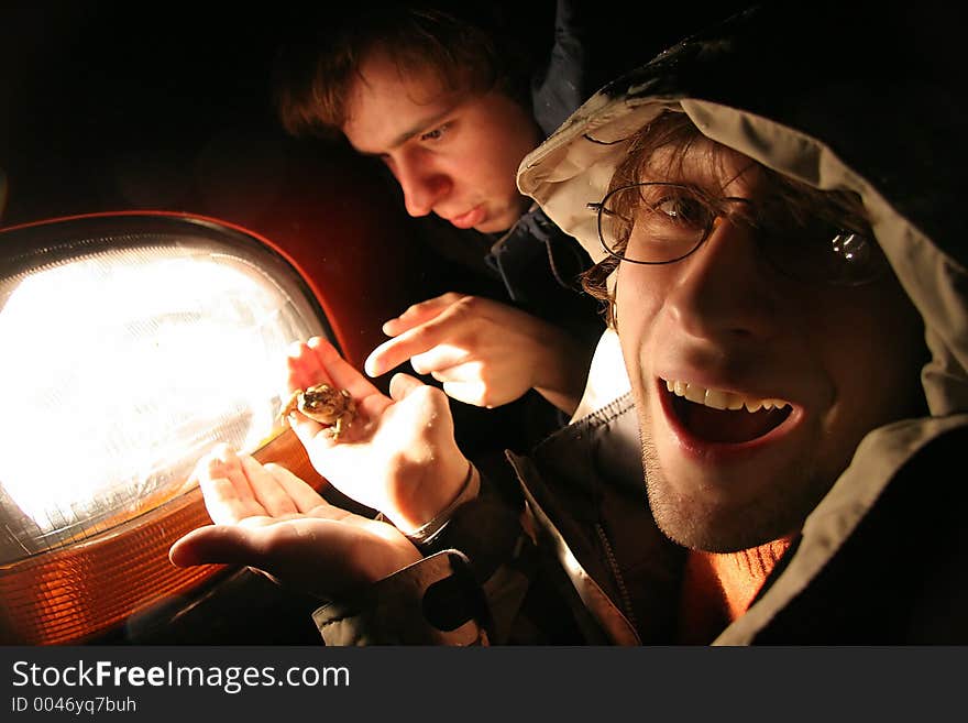 Two biologist with frog at night. Two biologist with frog at night